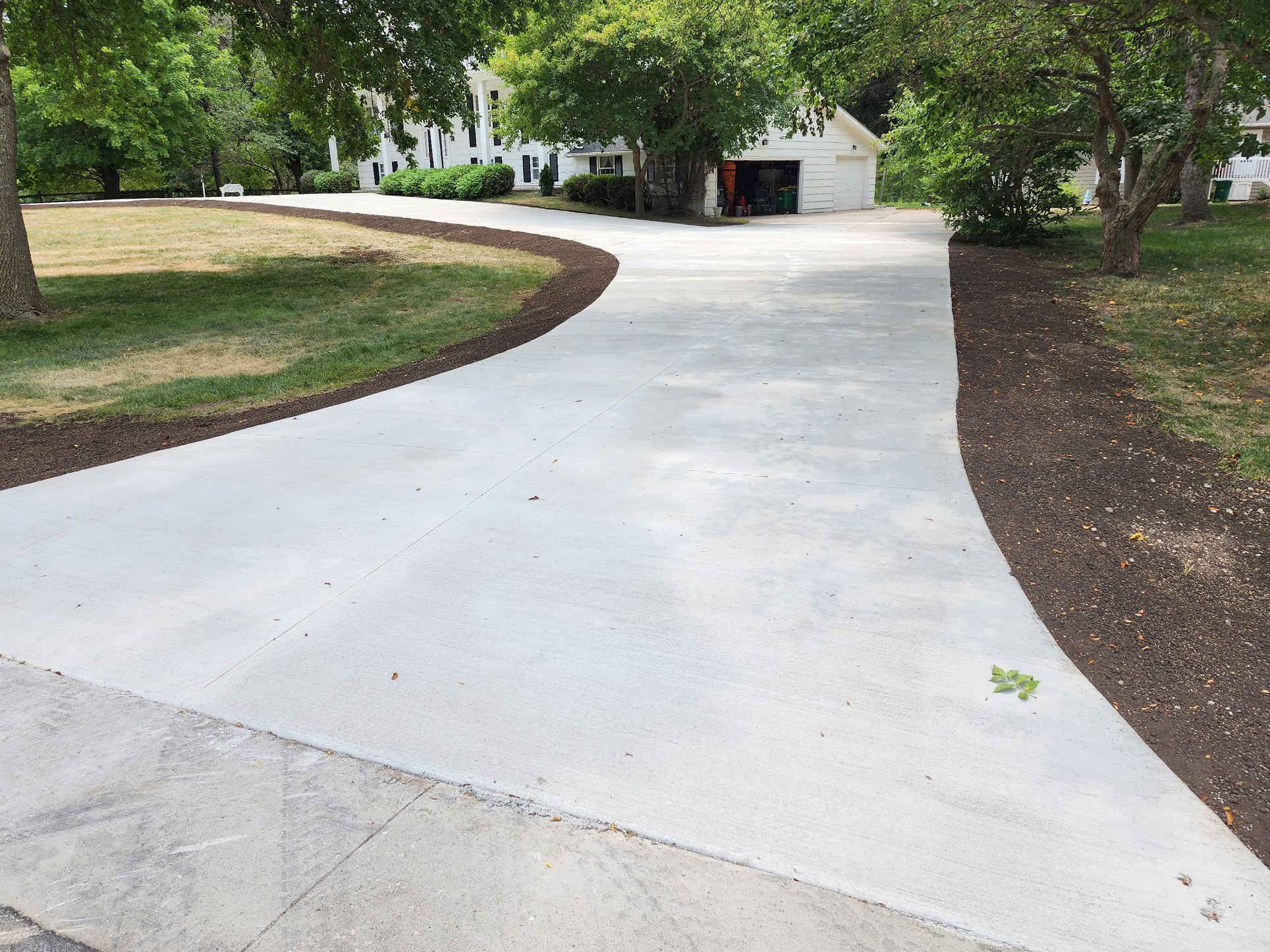 New concrete driveway entrance leading to the garage.
